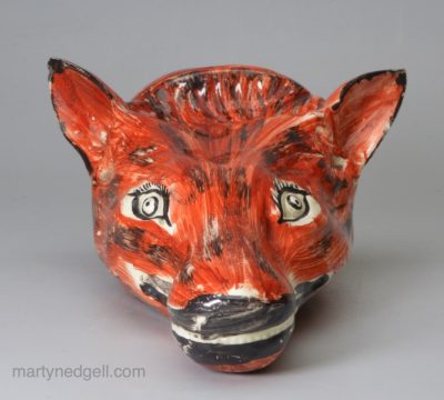 Creamware pottery fox head stirrup cup decorated with overglaze enamels, circa 1820