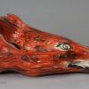 Creamware pottery fox head stirrup cup decorated with overglaze enamels, circa 1820