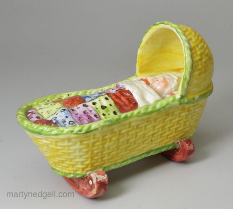 Pearlware pottery toy cradle and child, circa 1820