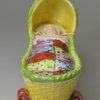 Pearlware pottery toy cradle and child, circa 1820