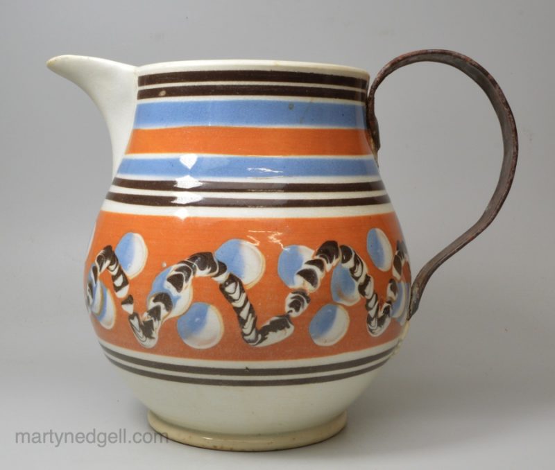 Mochaware snail trail and cat's eye decorated jug with a make do handle, circa 1820