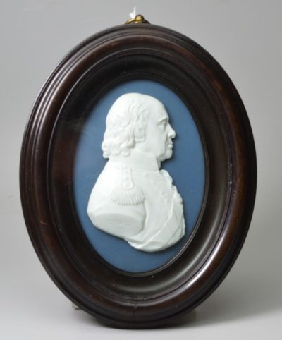 A portrait of Admiral Howe moulded in glass by James Tassie and dated 1798