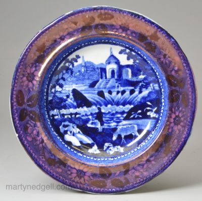 Pearlware pottery cup plate decorated with a blue transfer print and lustre border, circa 1820