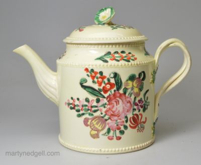 Creamware pottery teapot decorated with flowers over the glaze, circa 1780, probably Leeds Pottery