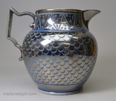 Blue coloured pottery jug decorated with silver resist lustre, circa 1820