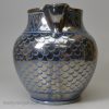 Blue coloured pottery jug decorated with silver resist lustre, circa 1820