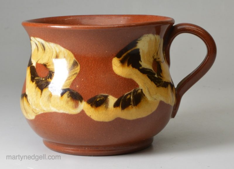 Brown pottery mug decorated with mocha snail trail, circa 1830