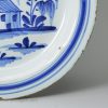 London delft plate painted in blue with a naive house, circa 1720