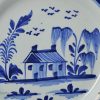 London delft plate painted in blue with a naive house, circa 1720