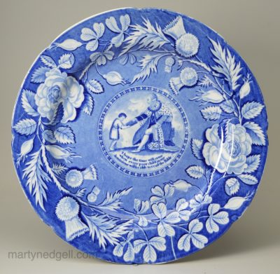 Pearlware pottery plate with an underglaze blue transfer print of George III giving the Bible to a poor child, circa 1820