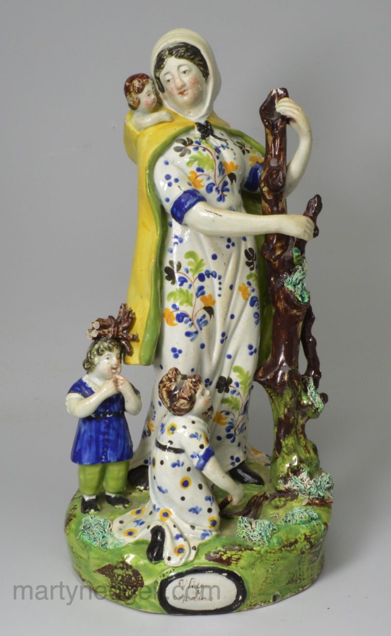 Large Staffordshire pearlware pottery figure of the Widow and orphans, circa 1820