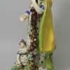 Large Staffordshire pearlware pottery figure of the Widow and orphans, circa 1820