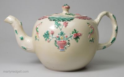 Staffordshire saltglaze teapot decorated with sprigs and enamels, circa 1760