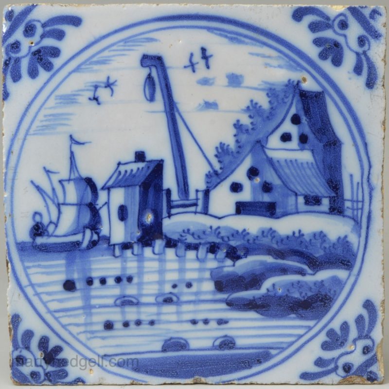 London delft tile painted in blue with a harbour scene, circa 1750