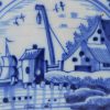 London delft tile painted in blue with a harbour scene, circa 1750