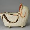 Bovey Tracey creamware pottery model of a cradle with a young child, circa 1800