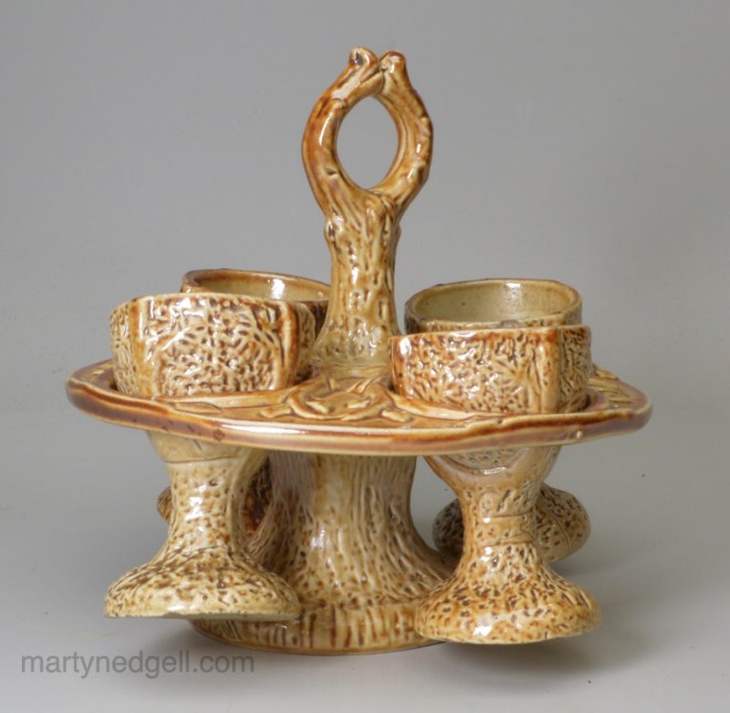 English brown saltglaze egg cup stand and four egg cups, circa 1840 Brampton Pottery