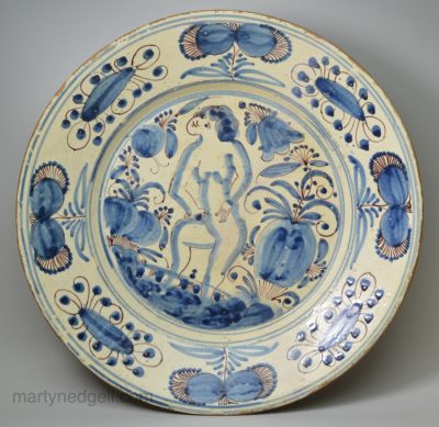 Large Portuguese tin glaze charger, circa 1650 painted with a figure in blue and manganese