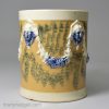 Creamware pottery mug decorated with tan slip and blue sponge marks under the glaze, circa 1790