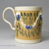 Creamware pottery mug decorated with tan slip and blue sponge marks under the glaze, circa 1790