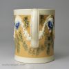 Creamware pottery mug decorated with tan slip and blue sponge marks under the glaze, circa 1790