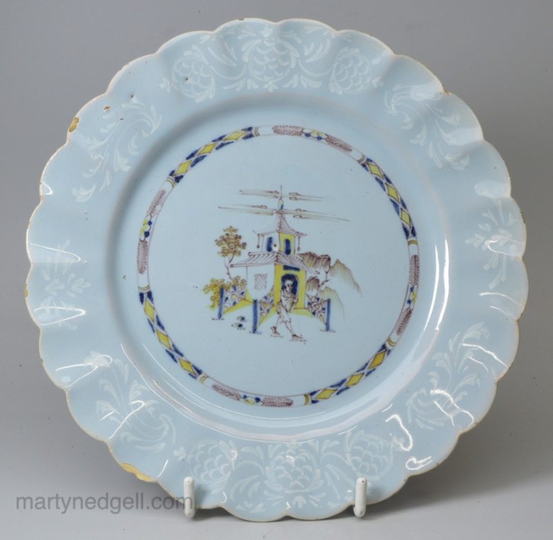 Bristol delft polychrome plate with a pine cone bianco sopra bianco border, circa 1750