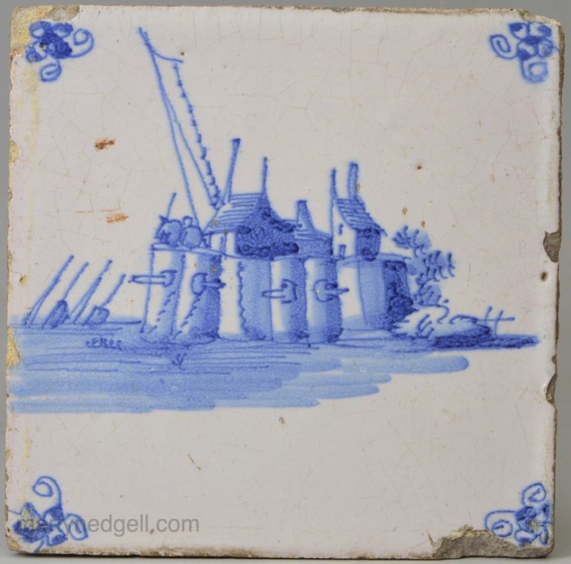 Dutch Delft tile painted with a fortified costal town, circa 1750