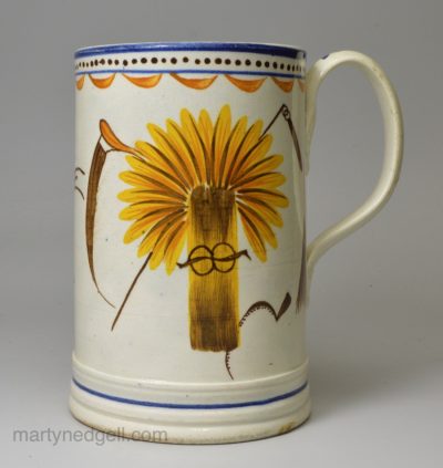 Prattware pottery farmer's mug decorated with enamels under the glaze, circa 1820