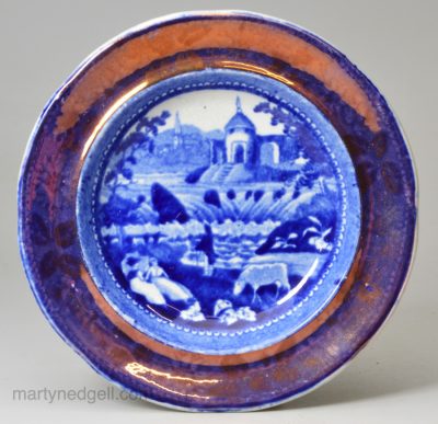 Pearlware pottery cup plate decorated with blue transfer and pink lustre border, circa 1820