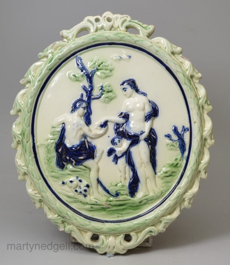 Pearlware pottery plaque moulded with Paris and Aphrodite and coloured under the glaze, circa 1800