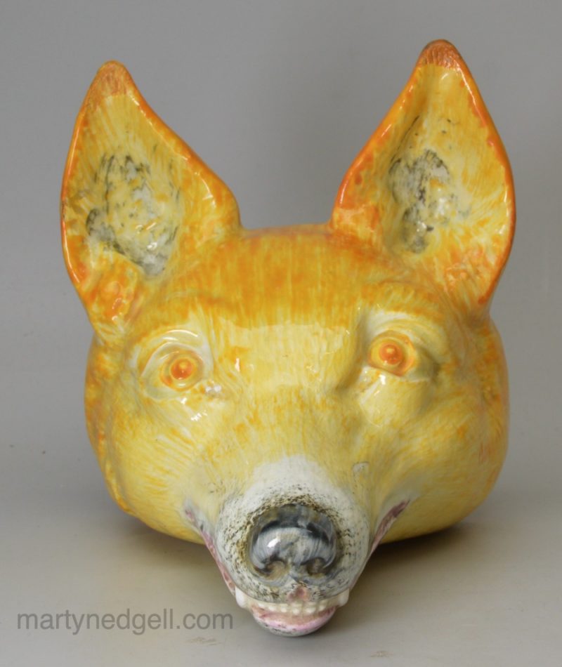 Oversize pearlware pottery fox head stirrup cup decorated with underglaze oxides, circa 1820