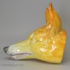 Oversize pearlware pottery fox head stirrup cup decorated with underglaze oxides, circa 1820