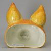 Oversize pearlware pottery fox head stirrup cup decorated with underglaze oxides, circa 1820