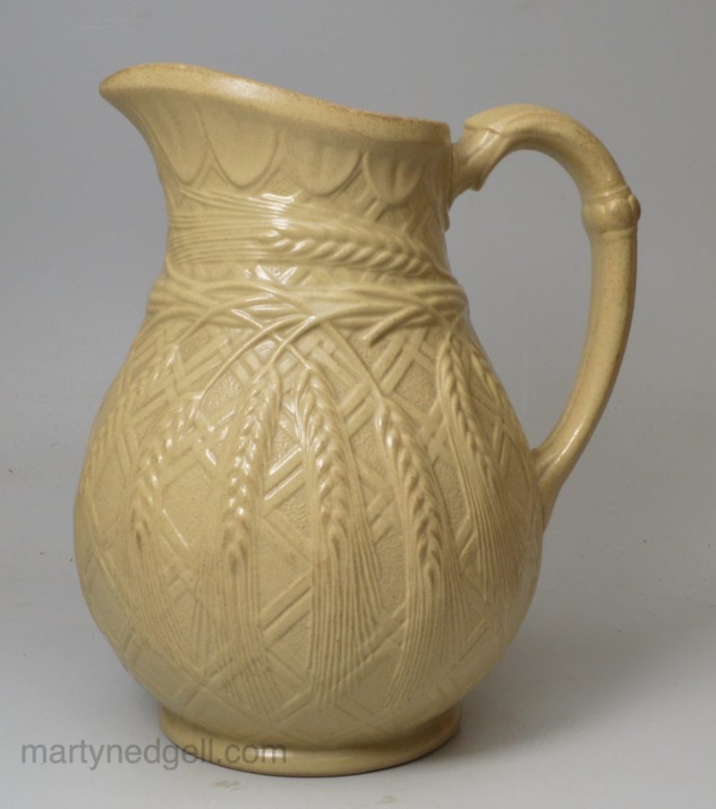 Buff coloured stoneware jug moulded with wheat ears, circa 1850