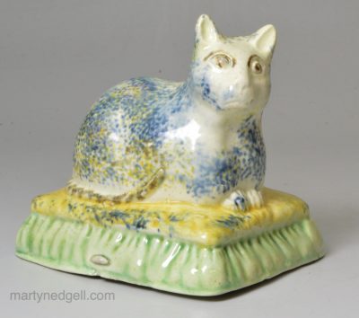 Creamware pottery cat with sponged decoration under the glaze, circa 1820