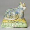 Creamware pottery cat with sponged decoration under the glaze, circa 1820