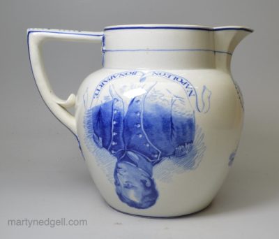 Rare syphoning pearlware pottery commemorative puzzle jug with blue prints of Napoleon and Wellington under the glaze, circa 1815