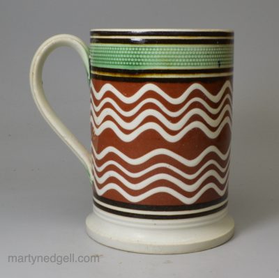 Mochaware pottery mug with slip decoration, circa 1820