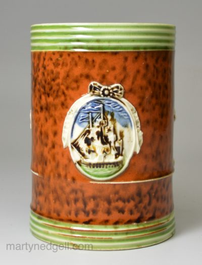 Creamware pottery commemorative mug, Battle of the Saintes with sprigs of the ship Ville De Paris, Lord Hood and Lord Rodney, circa 1795