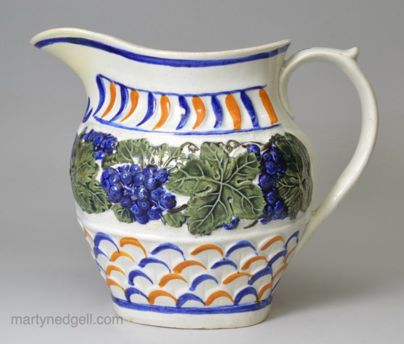 Prattware pottery jug moulded with vine leaves and grapes, circa 1820