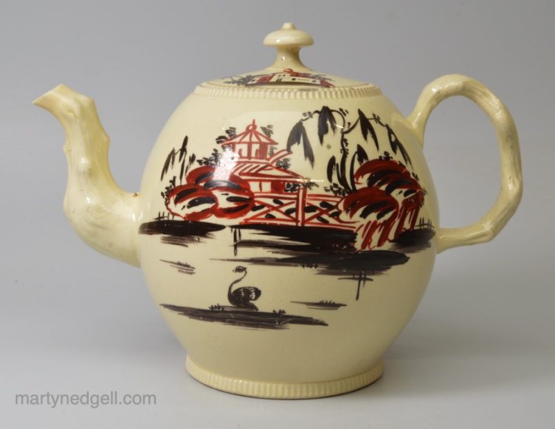 Creamware pottery teapot decorated with black and red enamels, circa 1770, probably Cockpit Hill Pottery