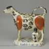 Pearlware pottery cow creamer decorated with colours under the glaze, circa 1820