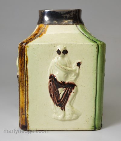 Creamware pottery tea canister moulded with Apollo and decorated with underglaze colours, circa 1770