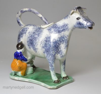 Pearlware pottery cow creamer decorated with colours under the glaze, circa 1820