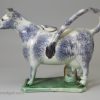 Pearlware pottery cow creamer decorated with colours under the glaze, circa 1820