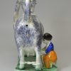 Pearlware pottery cow creamer decorated with colours under the glaze, circa 1820