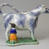 Pearlware pottery cow creamer decorated with colours under the glaze, circa 1820