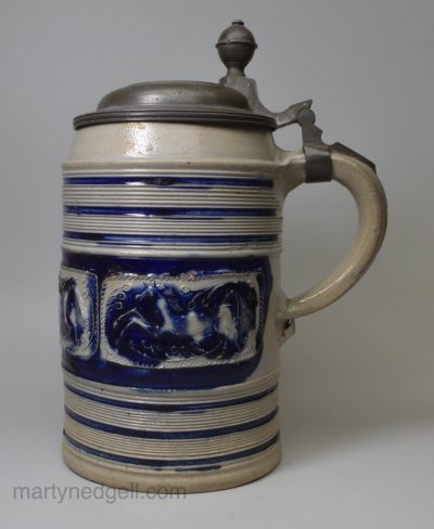 Large Westerwald saltglaze stoneware tankard decorated with panels of horses, circa 1740