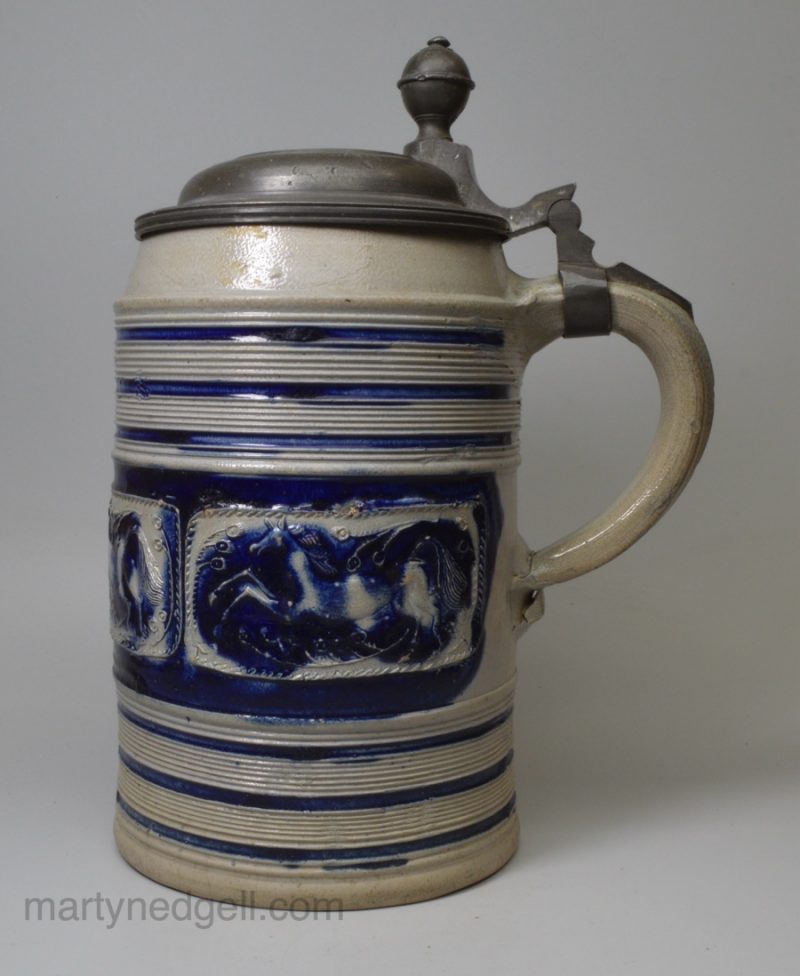 Large Westerwald saltglaze stoneware tankard decorated with panels of horses, circa 1740