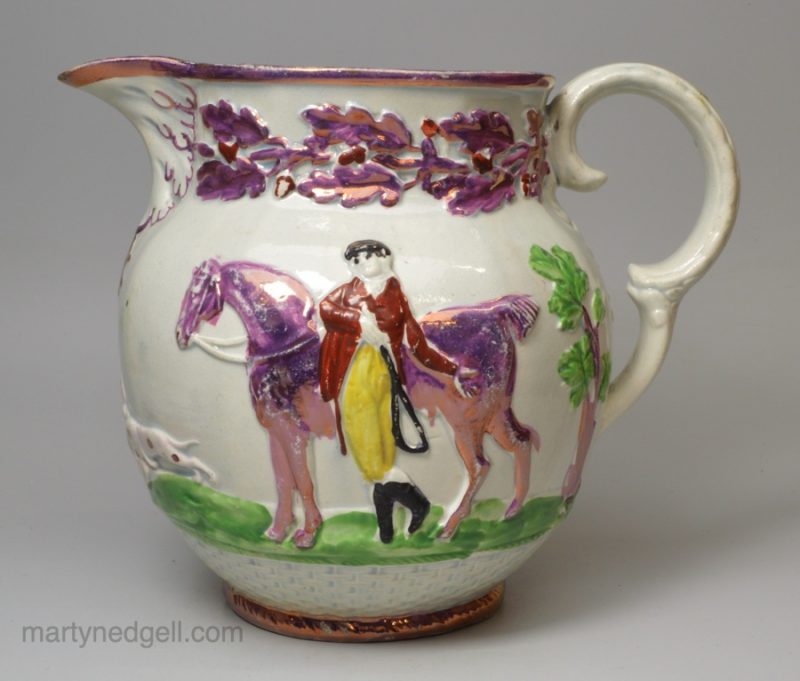 Pearlware pottery jug moulded with equestrian figures and decorated with overglaze enamels and pink lustre, circa 1820